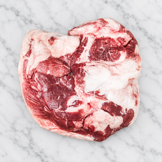 Raw Mangalitsa boneless picnic pork shoulder on white marble; AI-assisted background edit of original product photograph