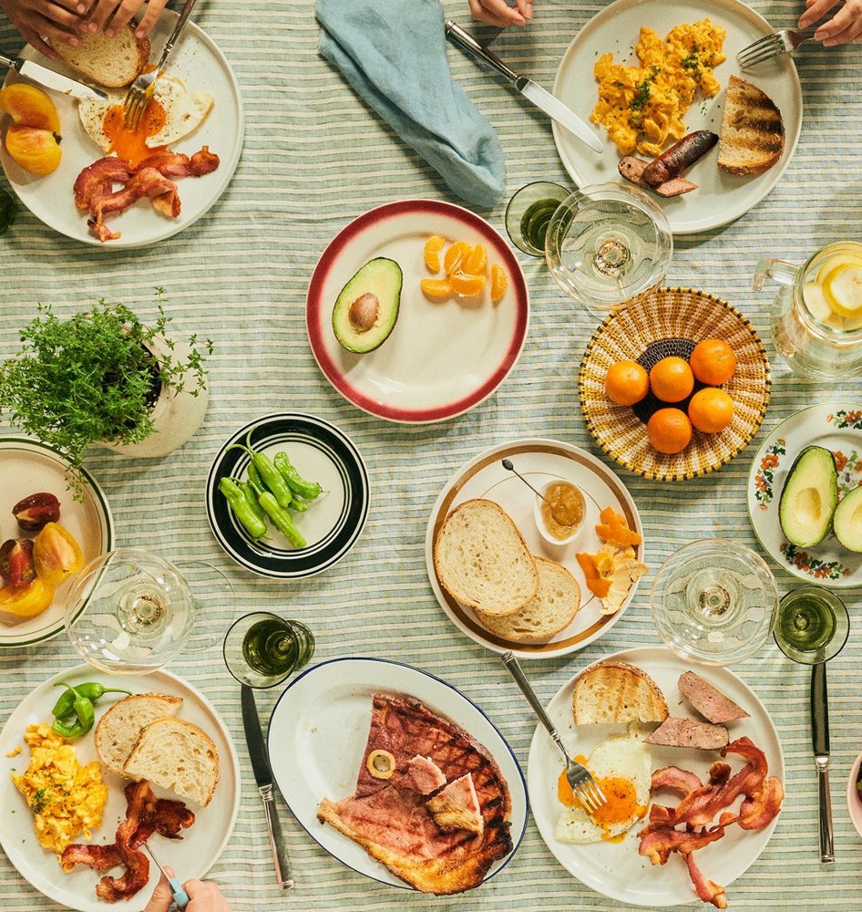 Family breakfast table featuring Mangalitsa pork with eggs, bread and fruit
